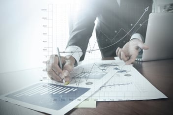 close up of business person analyzing charts