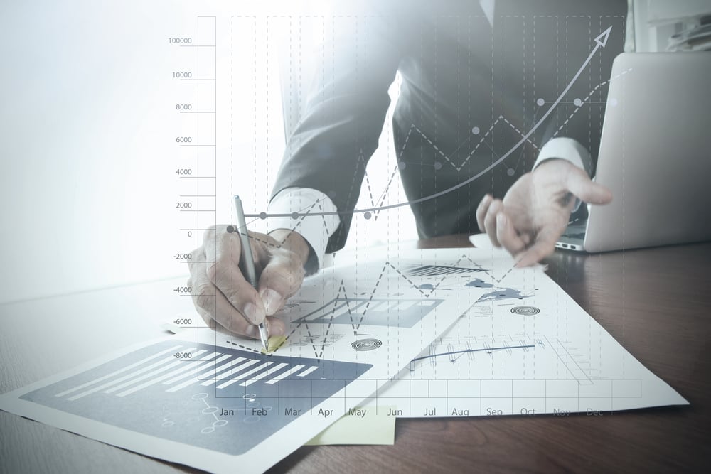 close up of business person analyzing charts